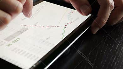 Trader using tablet for checking stock data.