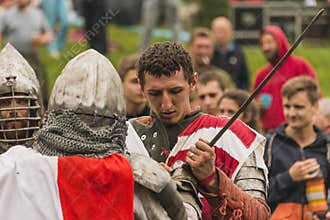 Participants of the festival in knight armor prepares to fights.