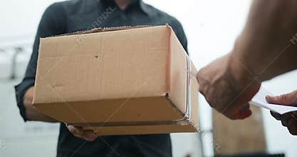Delivery man delivering package to customer, close up at and and box