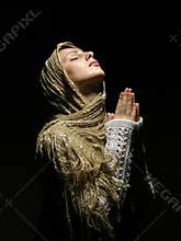 Young and beautiful girl praying