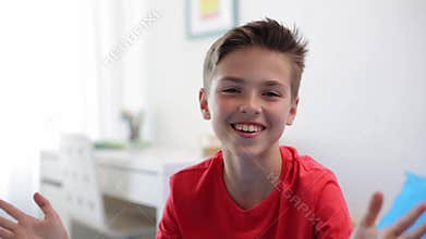 Happy smiling preteen boy talking at home
