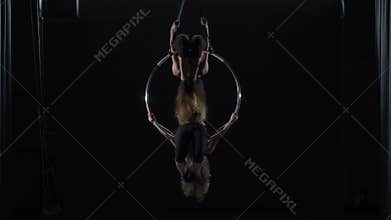 Two girls are dancing on the aerial hoop
