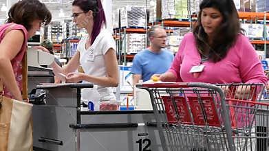 Motion of cashier scanning food and stocking them on trolley at check out counter