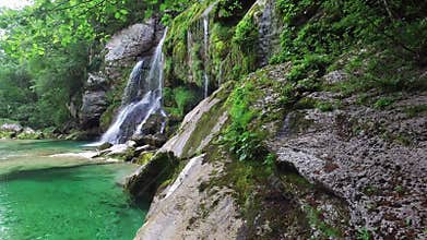 4K. Waterfall Virje in Slovenian Alps, clean blue water and green forest. Julian Alps, Bovec district, Slovenia, Europe