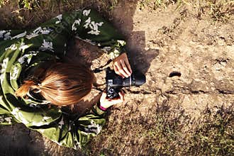Photographer is taking a photo of caterpillar walking on the road.