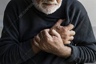 An elderly man is having a heart attack with chest pain