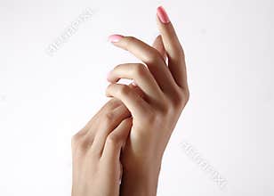Beautiful woman`s hands on light background. Care about hand. Tender palm. Natural manicure, clean skin. Pink nails
