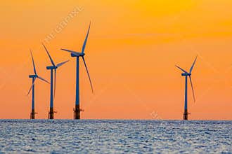 Offshore wind farm energy turbines at dawn. Surreal but natural