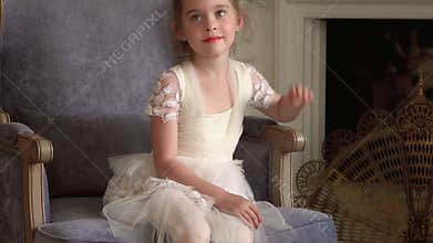 Legs of the little ballerina in white pointes. Legs close up