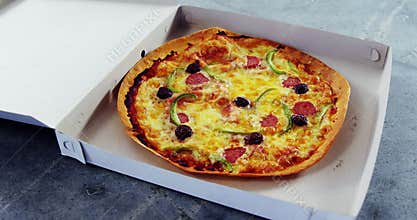 Baked pizza with olive and peperoni toppings