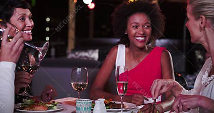 Group Of Female Friends Enjoying Meal At Rooftop Restaurant