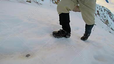 Man Climbing Up Snowy Mountain Ice Axe and Crampons