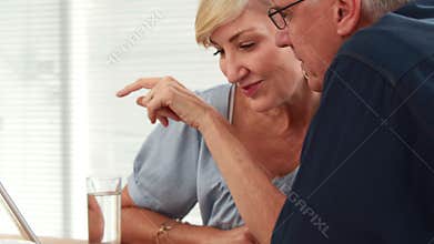 Casual business partners looking at tablet