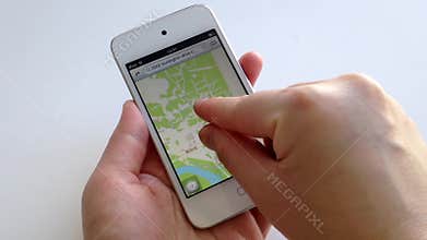 Woman hand searching map with the index finger on smart device