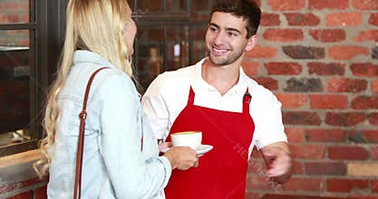 Smiling customer paying by credit card