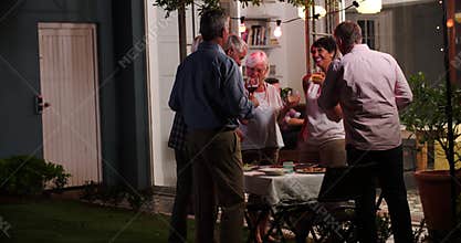 Group Of Friends Enjoying Outdoor Evening Drinks Party
