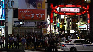 Time Lapse Pan of Busy Shinjuku Entertainment / Shopping District at Night - Tokyo Japan