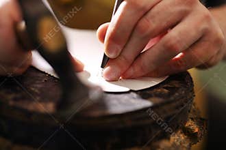 Shoemaker makes chisel holes in the skin grain
