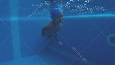 child jump to the pool and swimming under water
