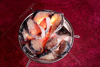 Slices of rohu fish on big sieve