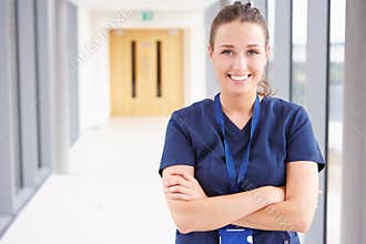 Portrait Of Female Nurse Standing In Hospital Corridor