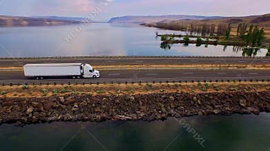 Truck crossing Columbia river with canyons in background