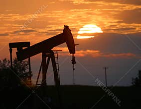 Oil pump jack at sunset