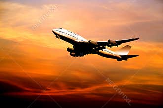 Airliner taking off at sunset