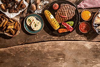 Grilled Meal Spread Out on Rustic Wooden Table