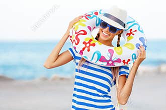 Beach woman happy and colorful wearing sunglasses and beach hat having summer fun during travel holidays vacation