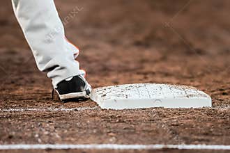 Baseball player with he's feet touching the base plate