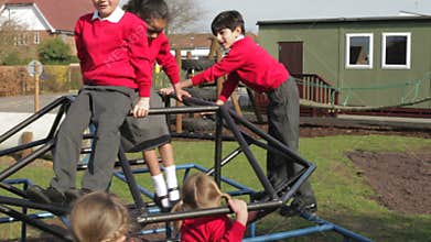 Group Of Elementary School Children On Climbing Frame