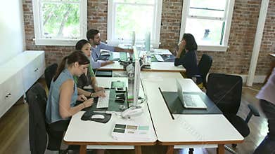 Time Lapse Sequence Of Workers At Desks In Design Office