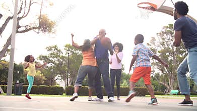 Multi Generation Family Playing Basketball In Slow Motion