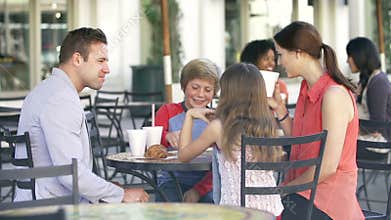 Slow Motion Sequence Of Family Enjoying Snack At Cafï¿½