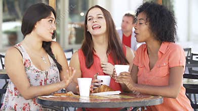 Three Female Friends Meeting In Cafï¿½