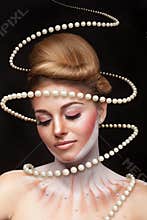 Surreal art concept of girl with pearls arround her
