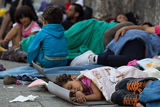 Refugee child sleeping at Keleti train station in Hungary