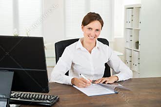 Businesswoman Writing On Document