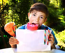 boy with cotton candy and sheet of paper