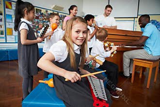 Group Of Children Playing In School Orchestra Together