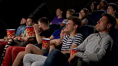 Young people watch movies in cinema: horror
