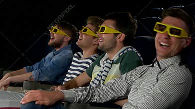 Young friends watching a film at the cinema. Close