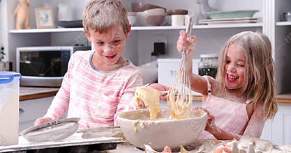 Children Having Messy Fun Baking In Kitchen