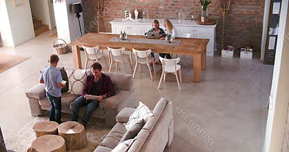 Overhead View Of Family Sitting On Sofa With Digital Devices