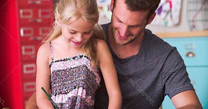 Father And Daughter Coloring Picture In Child's Bedroom