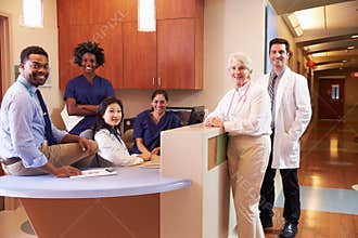 Portrait Of Medical Staff At Nurse's Station In Hospital