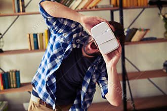 Handsome man very excited using virtual reality glasses