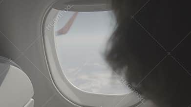 Man closes the window shutter on plane