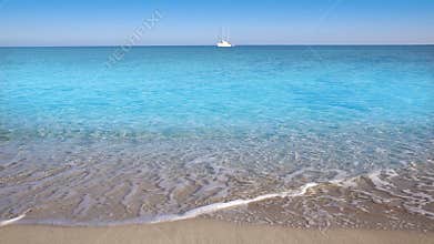 Perfect beach with sailboat in turquoise aqua color and the waves
